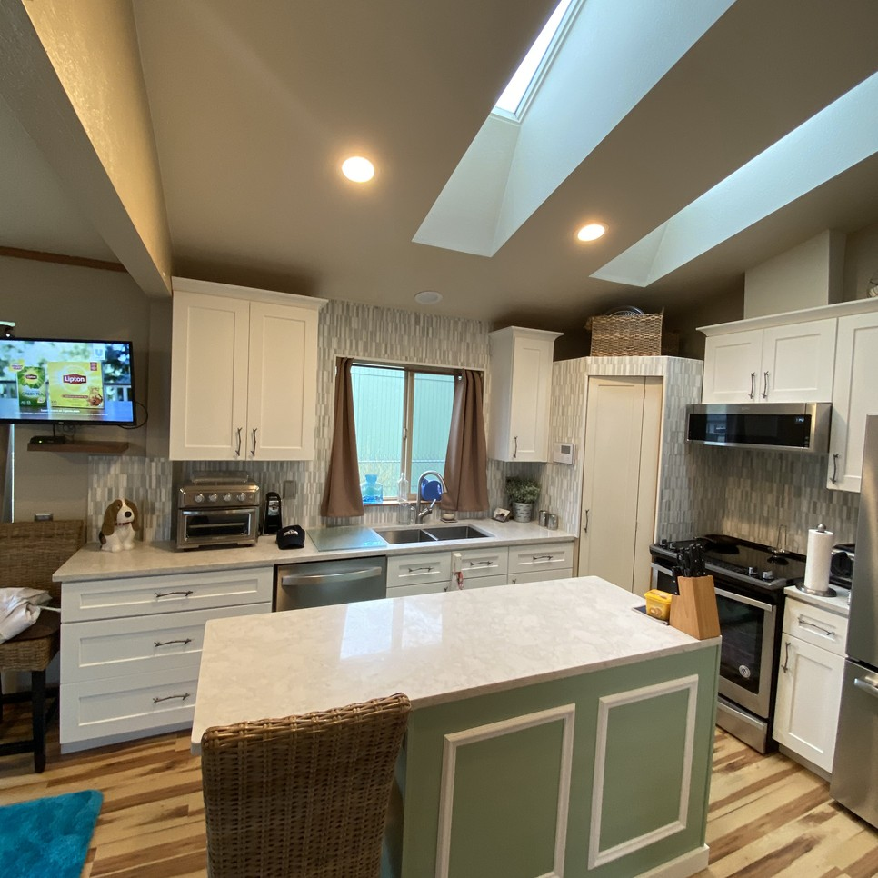 Kitchen remodel with new floors cabinets and paint